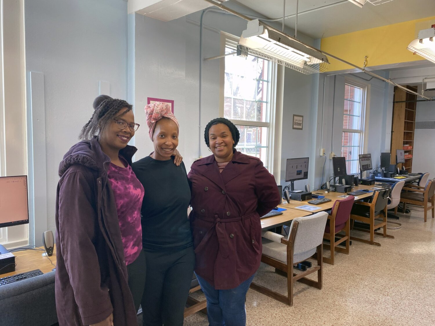 Jasmine Russell, center, poses in front of the new B.E.A.R. Academy computers with Director of Education and Training Tesshia Taylor, left, and Day Program Director Patricia Melgarejo.